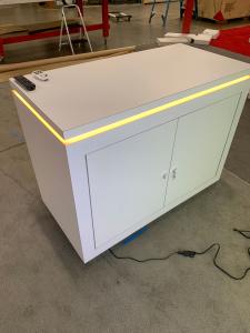 RENTAL: RE-1079 Inline Design with 110" Wide x 96" High Single-Sided Lightbox, Large Monitor Mount, 50" Monitor, RE-1576 Reception Counter, SEG Backlit Fabric Graphic, and Vinyl Applied Graphic -- View 4