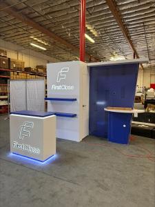 Modified VK-1132 Custom Exhibit with Backwall Counter, Storage Closet, Shelves, Monitor Mount, Backlit Logos, and MOD-1581 Counter with Locking Storage -- View 3