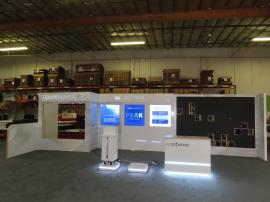 Custom Reconfigurable Inline Exhibit with Full-size Closet, Backlit Logos, Lightboxes, Reception Counter with LED Accent Lights, Riser, Product Display, and Opening for LED Video Tiles