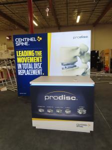 VK-1968 SuperNova Backlit Exhibit with Tension Fabric Graphic and Custom Counter with RGB Lights and Locking Storage