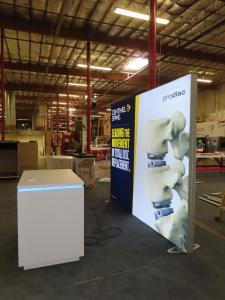 VK-1968 SuperNova Backlit Exhibit with Tension Fabric Graphic and Custom Counter with RGB Lights and Locking Storage -- View 3